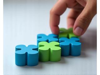 Hand meticulously placing investment blocks, symbolizing strategic investment coaching and portfolio optimization.